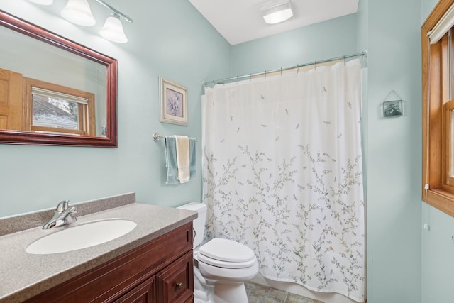 bathroom featuring a shower with curtain, vanity, and toilet