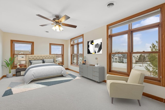 bedroom with ceiling fan and light colored carpet