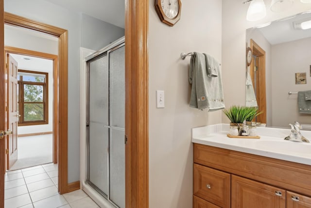 bathroom featuring tile patterned floors, vanity, and a shower with shower door