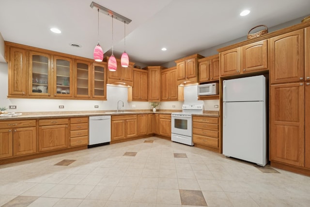 kitchen featuring sink, light tile patterned flooring, hanging light fixtures, and white appliances