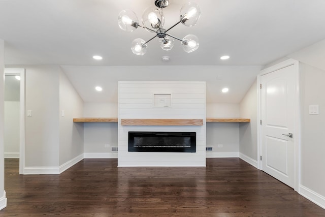 unfurnished living room featuring dark hardwood / wood-style floors and a large fireplace