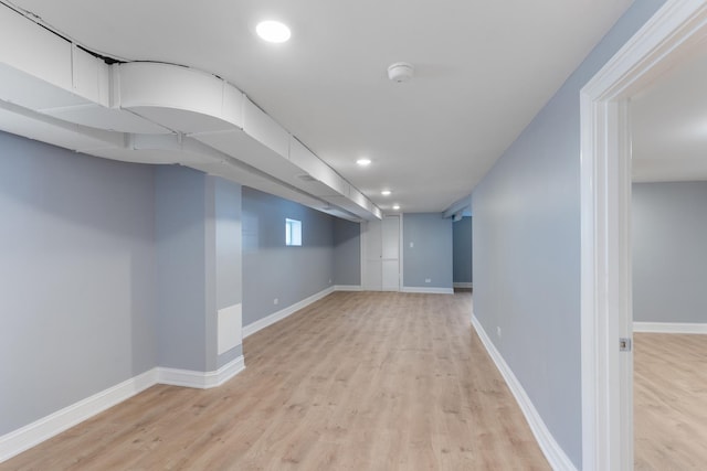 basement with light hardwood / wood-style floors