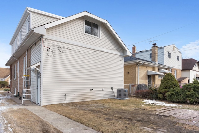 view of side of home with central AC