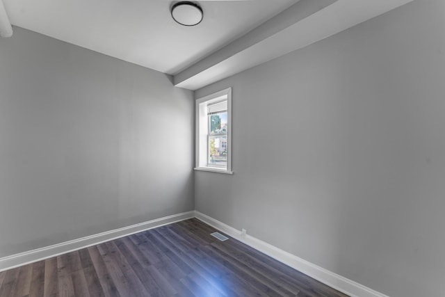 unfurnished room featuring dark hardwood / wood-style floors