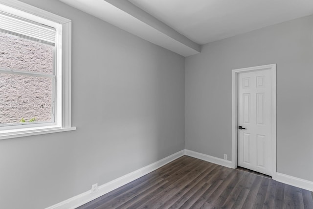 spare room featuring dark hardwood / wood-style flooring