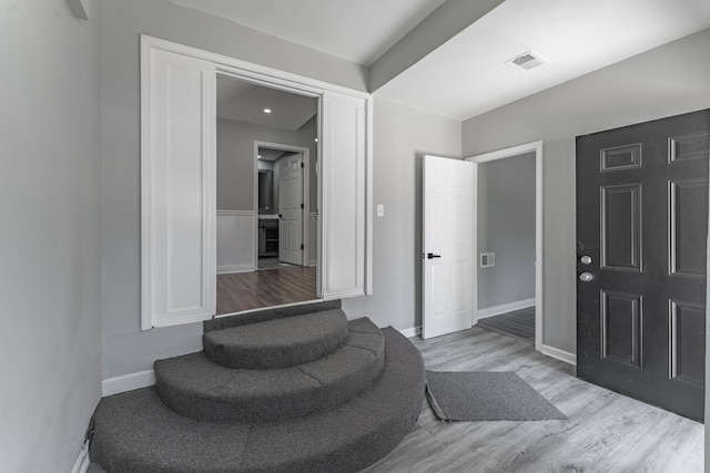 foyer with light hardwood / wood-style floors