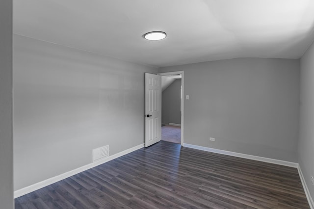 unfurnished room with dark wood-type flooring