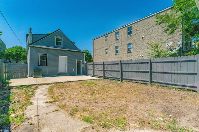 back of house featuring central AC unit and a patio area