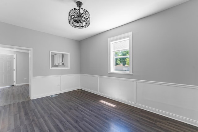 spare room featuring dark wood-type flooring