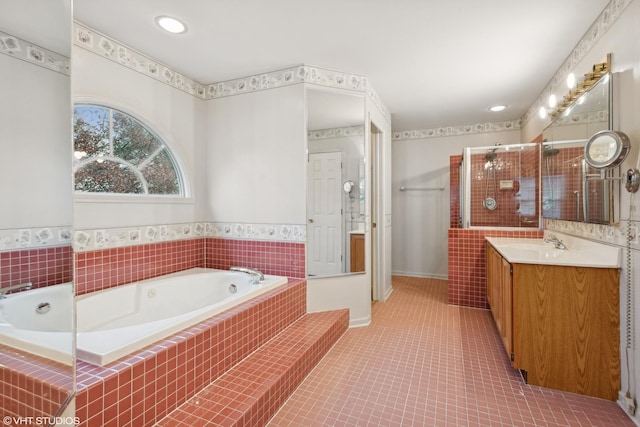 bathroom with vanity, tile patterned floors, and plus walk in shower