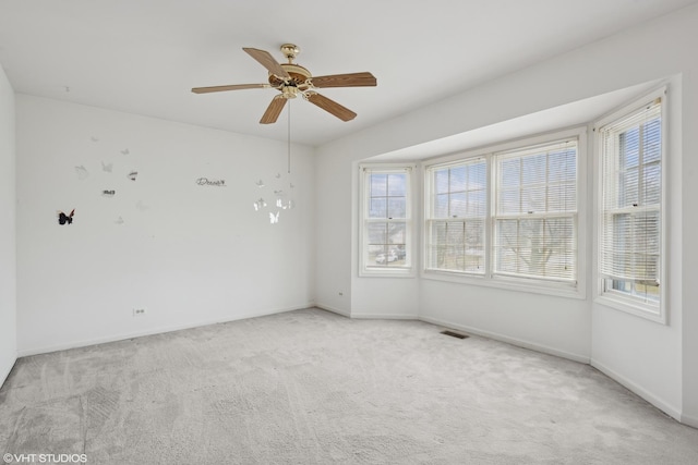 carpeted empty room with ceiling fan