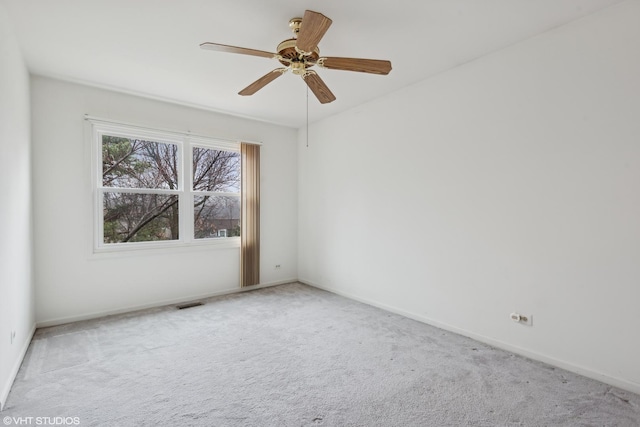 empty room with ceiling fan and carpet