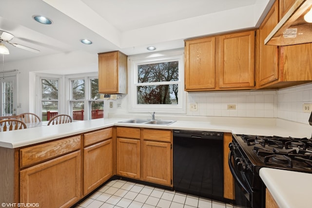 kitchen featuring premium range hood, sink, tasteful backsplash, kitchen peninsula, and black appliances