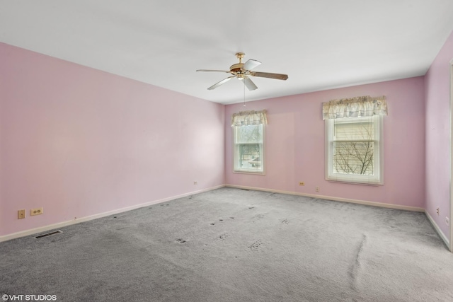 carpeted spare room featuring ceiling fan