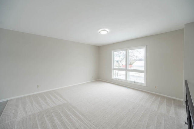 spare room with light colored carpet