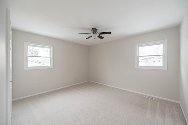 carpeted empty room featuring ceiling fan