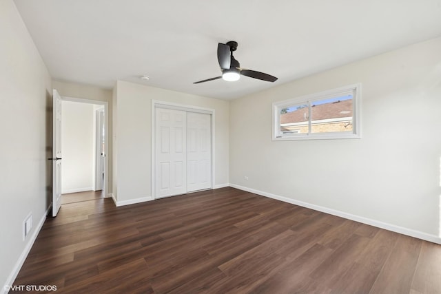 unfurnished bedroom featuring ceiling fan, a closet, and dark hardwood / wood-style floors