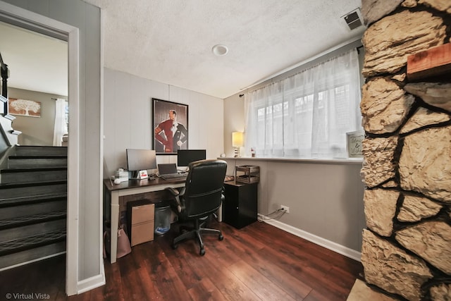 office area with dark wood-type flooring and a textured ceiling