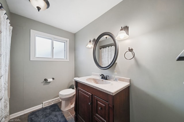 bathroom featuring toilet, vanity, tile patterned floors, and vaulted ceiling