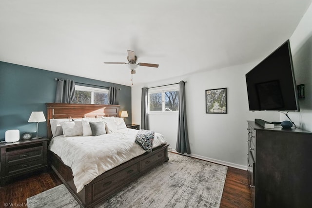 bedroom with ceiling fan and dark wood-type flooring