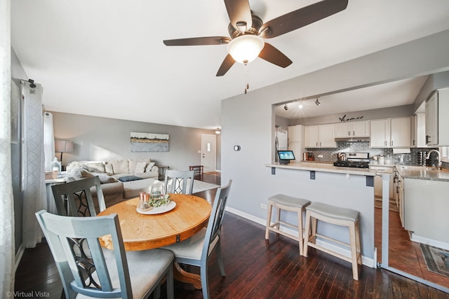 dining room featuring ceiling fan and dark hardwood / wood-style flooring