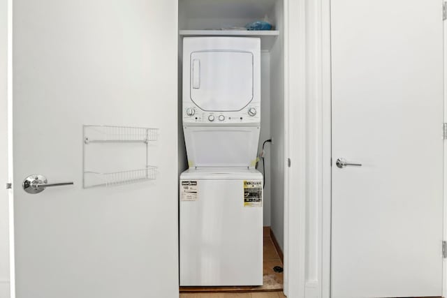 laundry room with stacked washer and dryer