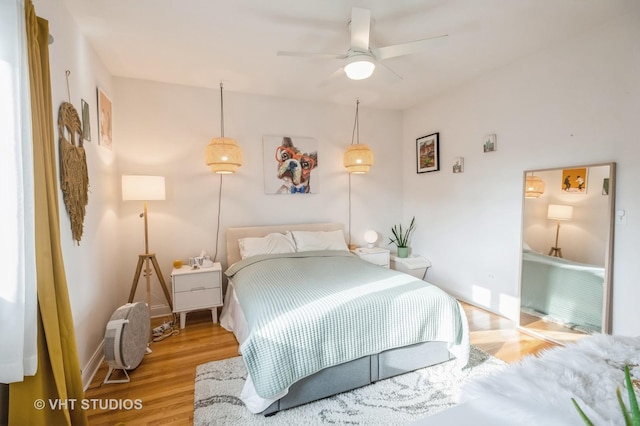 bedroom with ceiling fan and wood-type flooring