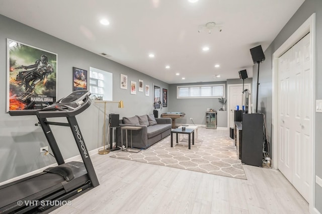 workout room with light hardwood / wood-style floors