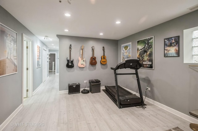 workout room featuring light wood-type flooring