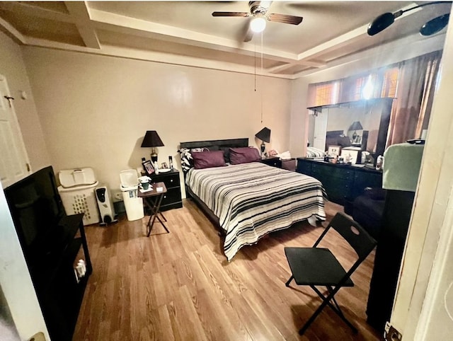 bedroom featuring hardwood / wood-style floors, ceiling fan, and coffered ceiling