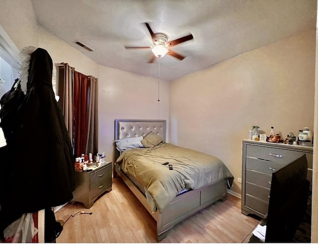 bedroom with ceiling fan and light hardwood / wood-style flooring