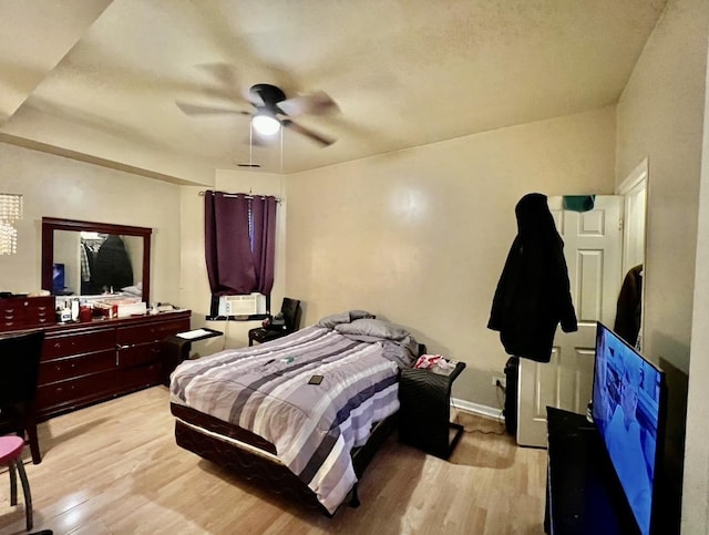 bedroom with ceiling fan and light wood-type flooring