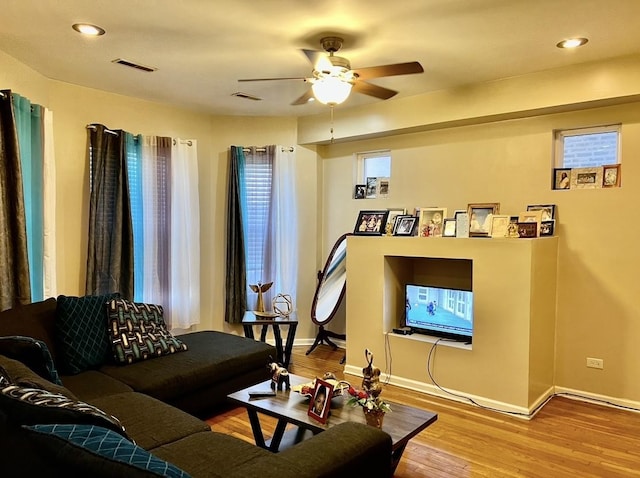 living room featuring hardwood / wood-style flooring and ceiling fan