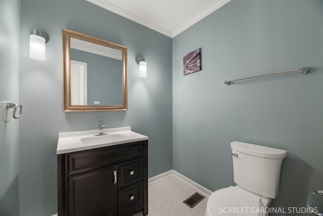 bathroom with tile patterned flooring, vanity, crown molding, and toilet