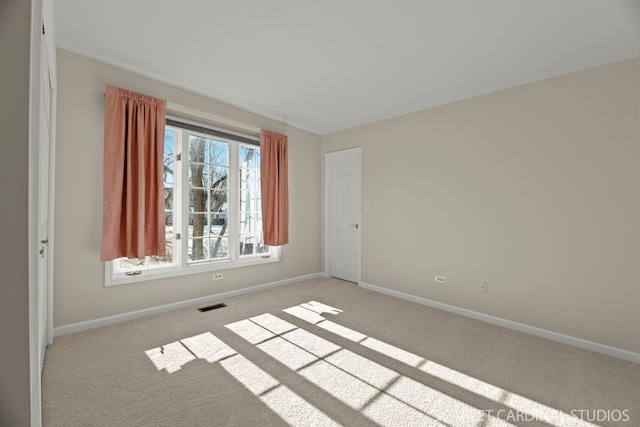 empty room with light colored carpet