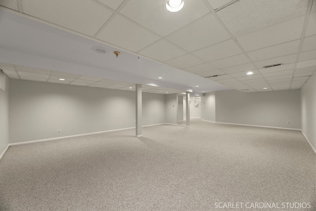 basement with carpet floors and a drop ceiling