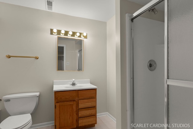 bathroom featuring tile patterned flooring, vanity, toilet, and walk in shower