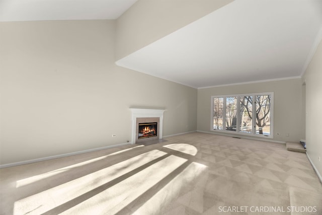 unfurnished living room featuring ornamental molding and light colored carpet