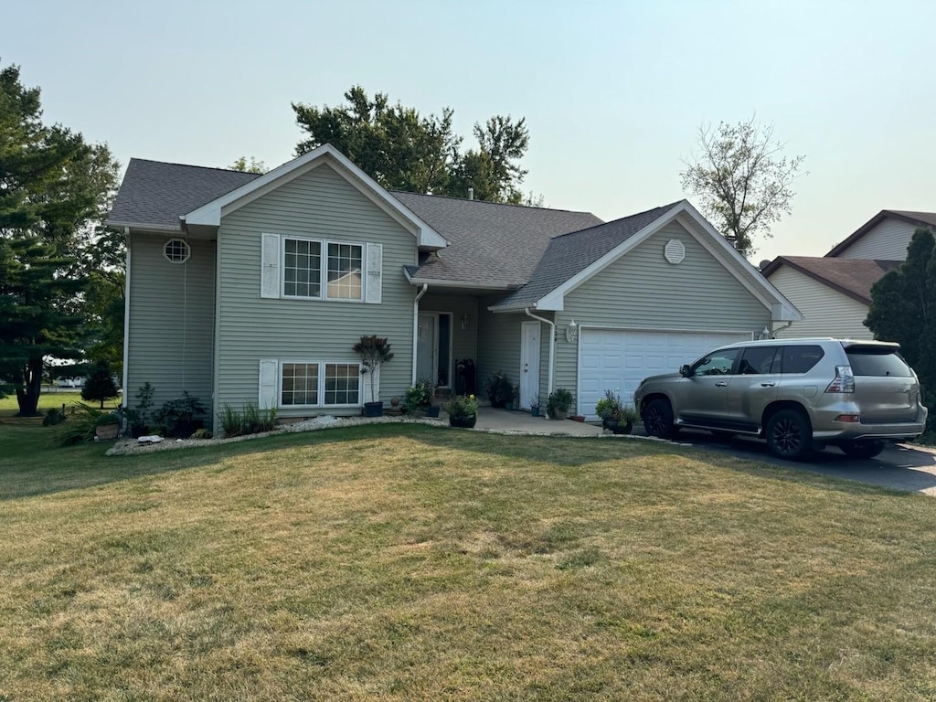 view of front of property with a front lawn and a garage