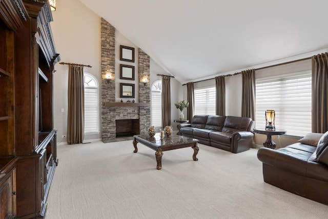 living room featuring plenty of natural light, light colored carpet, a fireplace, and high vaulted ceiling