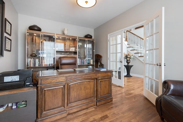 office with french doors and dark hardwood / wood-style flooring