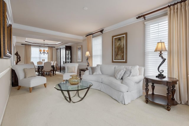 carpeted living room featuring a chandelier and ornamental molding