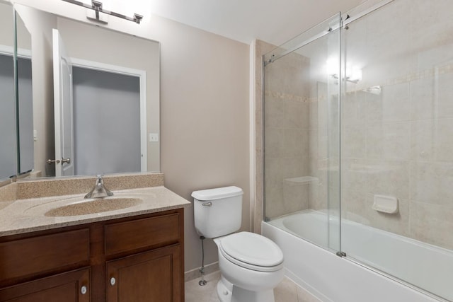 full bathroom featuring tile patterned floors, vanity, toilet, and bath / shower combo with glass door