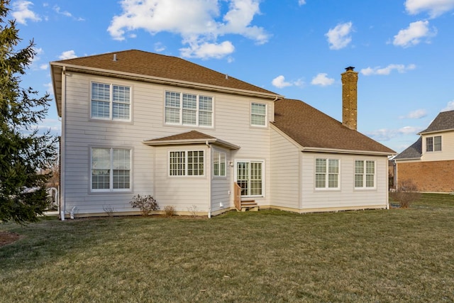 rear view of property featuring a yard