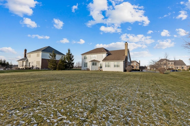 rear view of house with a yard