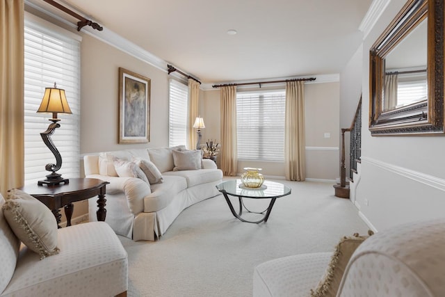 carpeted living room featuring a healthy amount of sunlight and ornamental molding