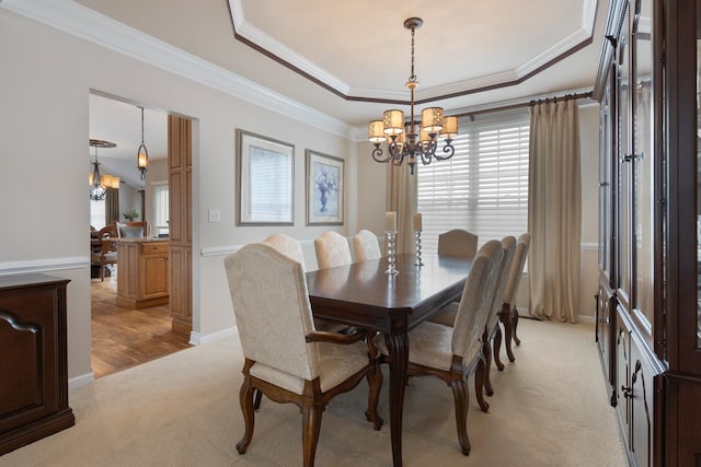 dining space featuring a notable chandelier, plenty of natural light, and ornamental molding