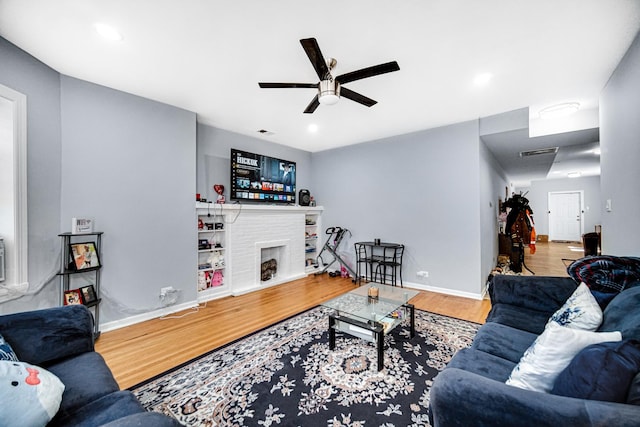 living room with ceiling fan and hardwood / wood-style floors