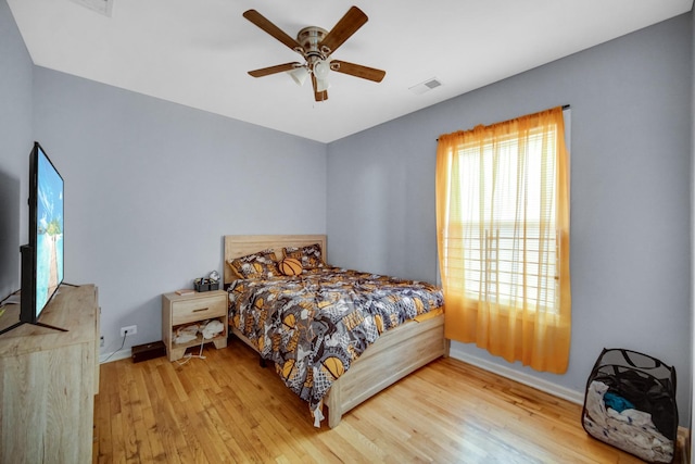 bedroom with ceiling fan and wood-type flooring