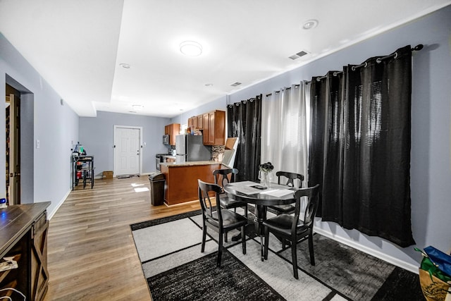 dining area with light hardwood / wood-style floors